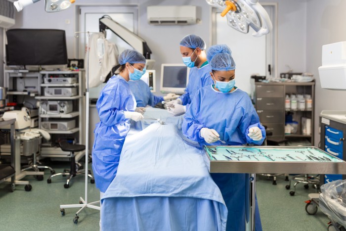 Medical team performing minimally invasive surgery in an operating room