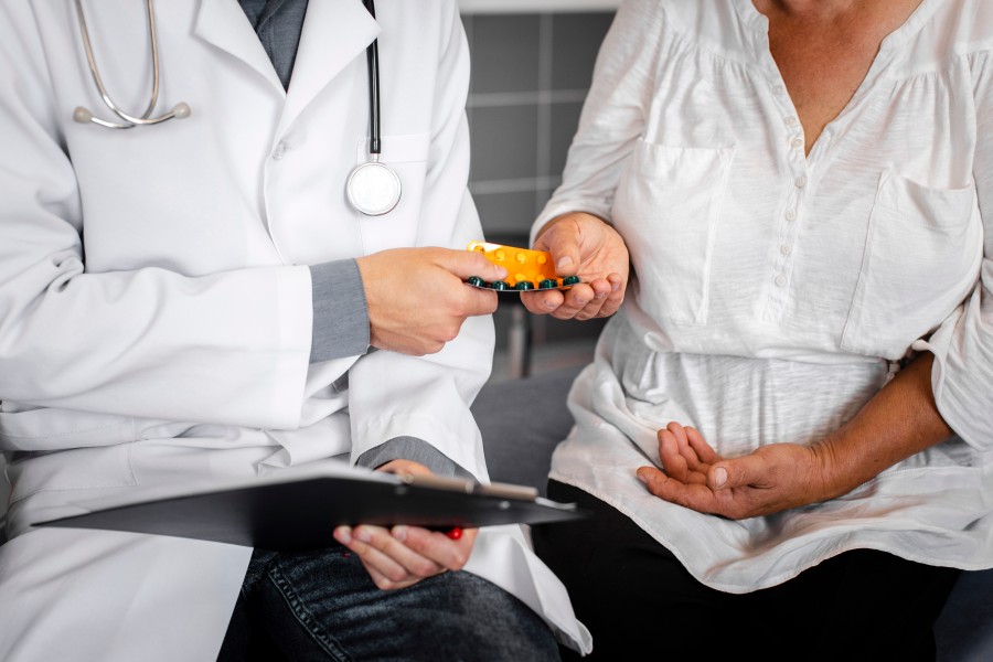 Doctor discussing Ureteric Disorder treatment with a patient while holding medication