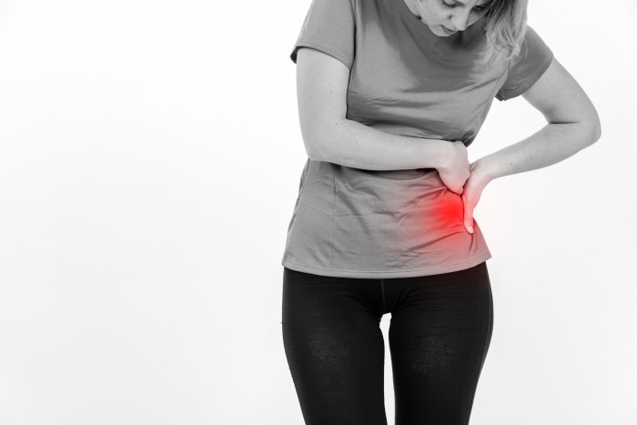 Woman experiencing kidney pain, highlighting the need for Kidney Stone treatment